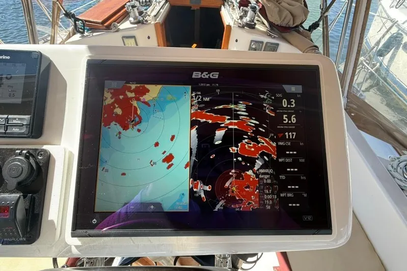  Yacht Photos Pics Navigation system on a 1998 Tartan 3500 sailboat, displaying marine charts and radar data.