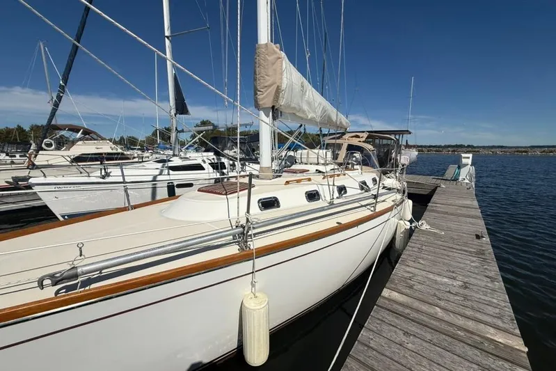  Yacht Photos Pics Sailboat docked at marina, Tartan 3500 model, 1998, under clear blue sky.