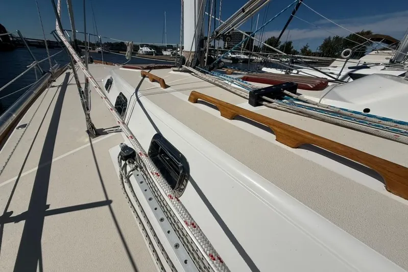  Yacht Photos Pics Deck view of a 1998 Tartan 3500 sailboat with rigging and wooden handrails.