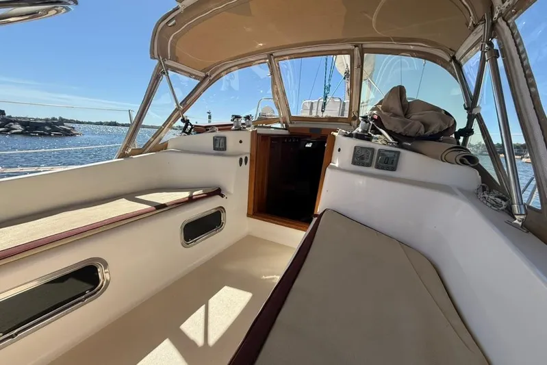  Yacht Photos Pics 1998 Tartan 3500 sailboat cockpit with beige seating, clear canopy, and ocean view.