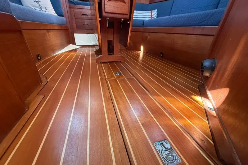  Yacht Photos Pics Interior of 1998 Tartan 3500 sailboat with polished wooden flooring and blue seating.
