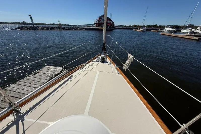  Yacht Photos Pics Bow view of 1998 Tartan 3500 sailboat docked in a serene marina.