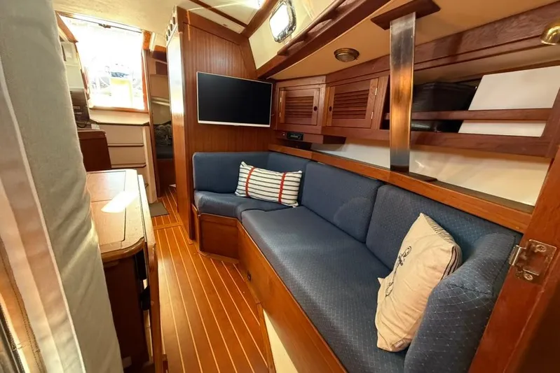  Yacht Photos Pics Interior of 1998 Tartan 3500 sailboat with cozy seating and wooden finishes.