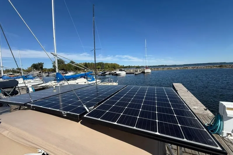  Yacht Photos Pics Solar panels on a 1998 Tartan 3500 sailboat docked at a marina.