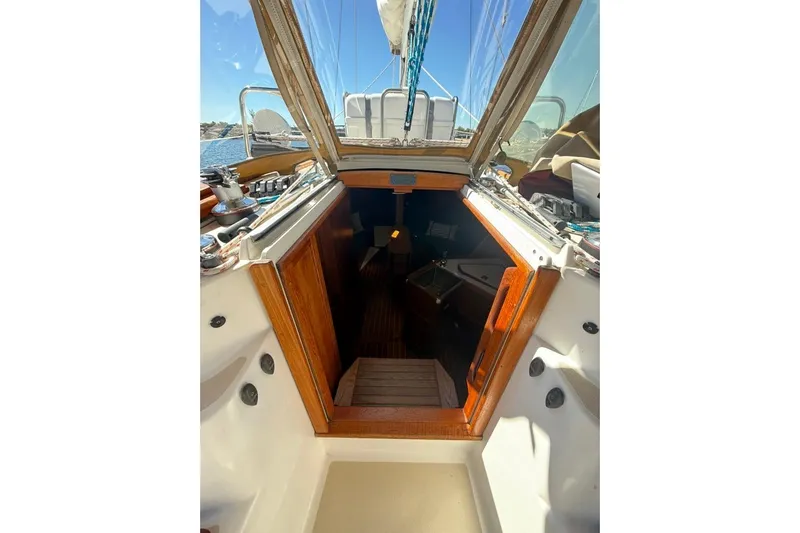  Yacht Photos Pics 1998 Tartan 3500 sailboat interior view with open hatch and wooden steps.