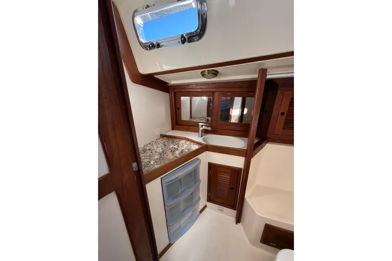  Yacht Photos Pics 1998 Tartan 3500 yacht interior with wooden cabinetry and compact sink area.