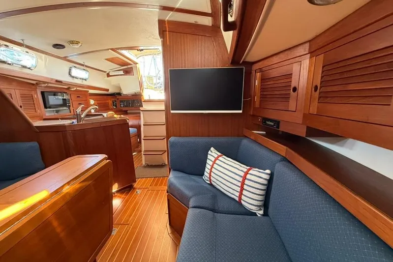  Yacht Photos Pics Interior of 1998 Tartan 3500 sailboat with wood finish, blue seating, and modern amenities.