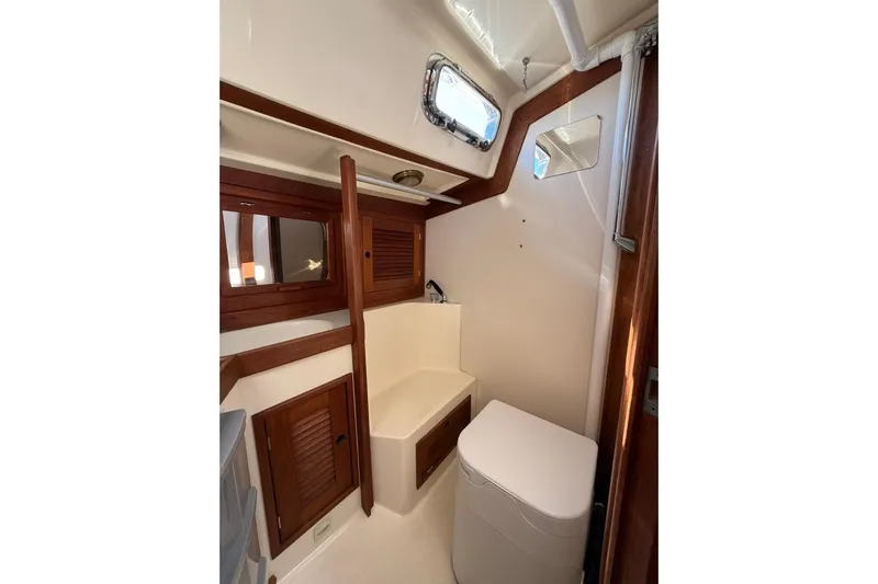  Yacht Photos Pics 1998 Tartan 3500 yacht interior with wooden cabinets and compact bathroom.