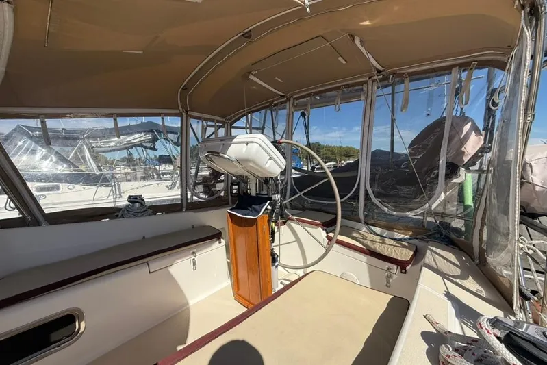  Yacht Photos Pics Interior view of a 1998 Tartan 3500 sailboat cockpit with steering wheel and seating.