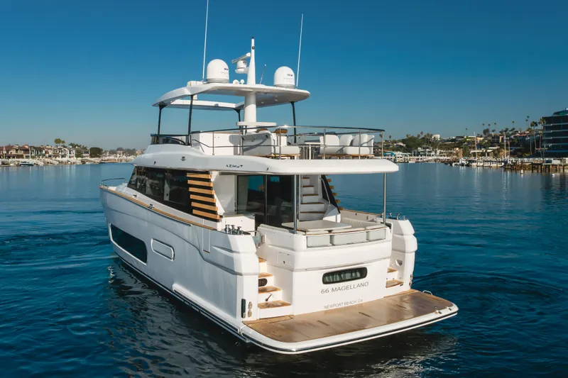66 Magellano Yacht Photos Pics 2023 Azimut Magellano 66 yacht cruising in a serene marina setting.