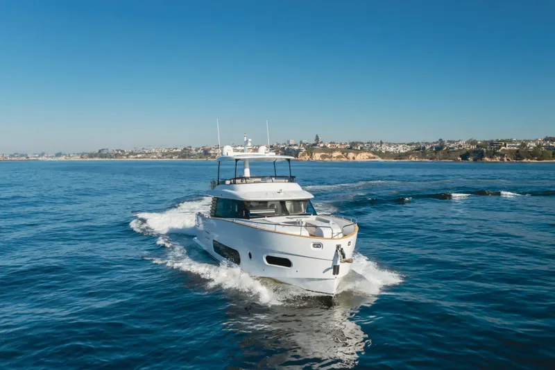 66 Magellano Yacht Photos Pics 2023 Azimut Magellano 66 yacht cruising on open water under clear blue skies.