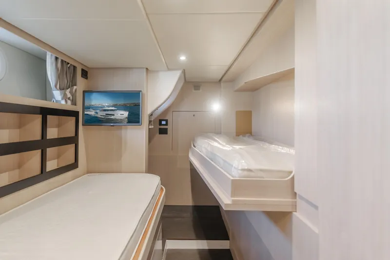 66 Magellano Yacht Photos Pics Interior of 2023 Azimut Magellano 66 yacht with modern bunk beds and wall-mounted TV.