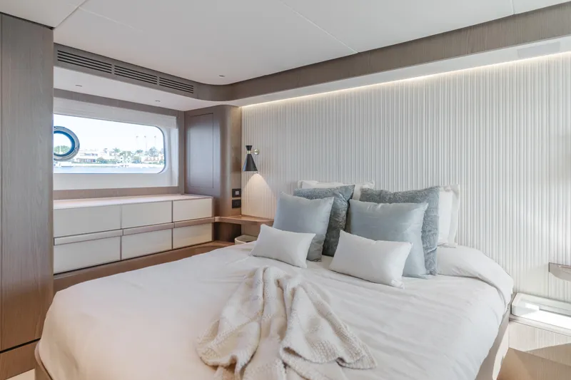66 Magellano Yacht Photos Pics Luxurious bedroom interior of 2023 Azimut Magellano 66 yacht with modern design and ocean view.