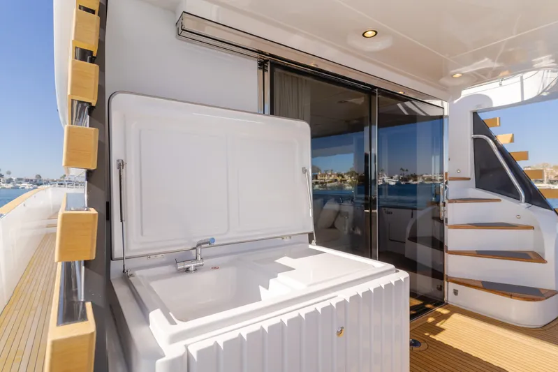 66 Magellano Yacht Photos Pics Outdoor sink area on 2023 Azimut Magellano 66 yacht, featuring sleek design and wooden accents.