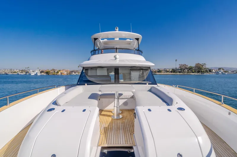 66 Magellano Yacht Photos Pics 2023 Azimut Magellano 66 yacht on calm water, showcasing luxurious deck and seating area.