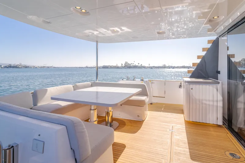 66 Magellano Yacht Photos Pics Luxurious Azimut Magellano 66 yacht deck with seating, table, and ocean view, 2023 model.