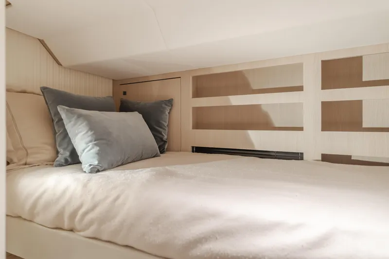 66 Magellano Yacht Photos Pics Cozy bedroom interior of 2023 Azimut Magellano 66 yacht with plush pillows.