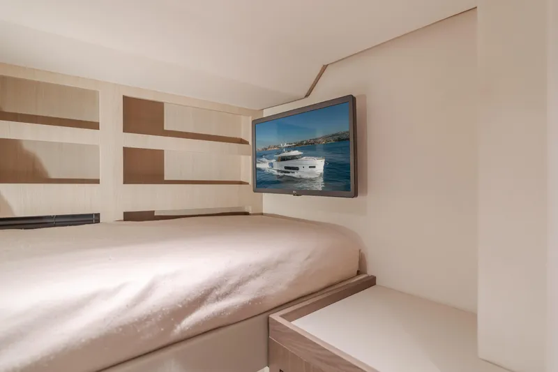 66 Magellano Yacht Photos Pics Interior of 2023 Azimut Magellano 66 yacht with bed and wall-mounted TV.