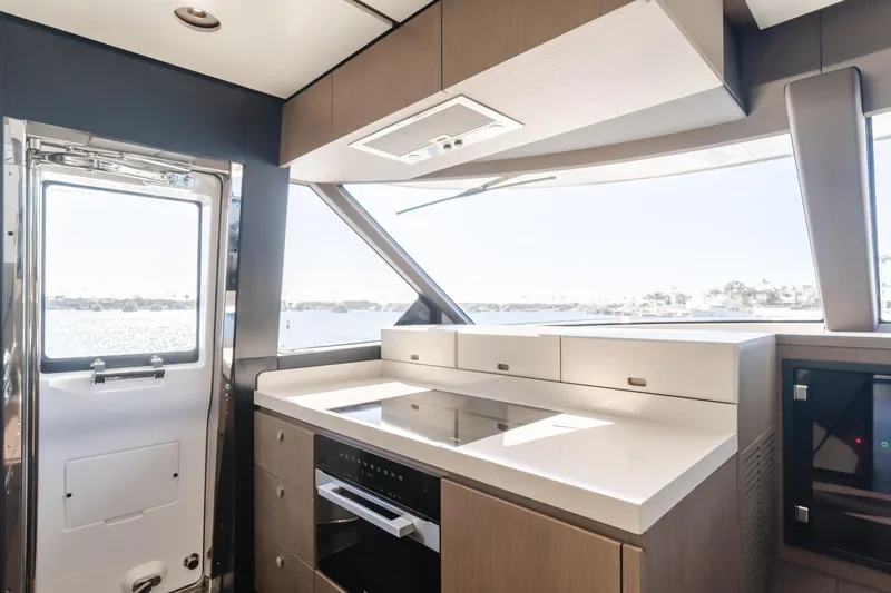 66 Magellano Yacht Photos Pics Modern kitchen interior on 2023 Azimut Magellano 66 yacht with sleek design and ocean view.