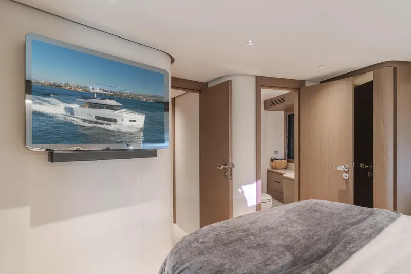 66 Magellano Yacht Photos Pics Luxurious interior of 2023 Azimut Magellano 66 yacht with modern decor and TV display.