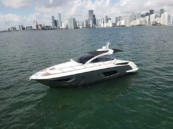  Yacht Photos Pics Azimut Atlantis 43 yacht, 2012 model, cruising near a city skyline on a sunny day.