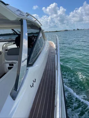  Yacht Photos Pics Azimut Atlantis 43 yacht cruising on clear blue water under a partly cloudy sky.