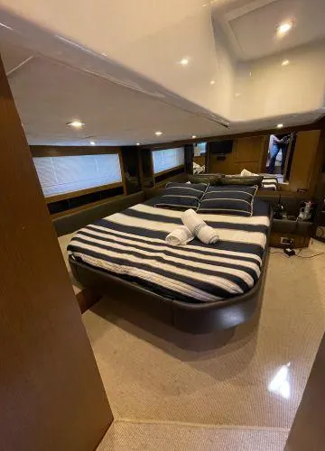  Yacht Photos Pics Luxurious bedroom interior of 2012 Azimut Atlantis 43 yacht with striped bedding.