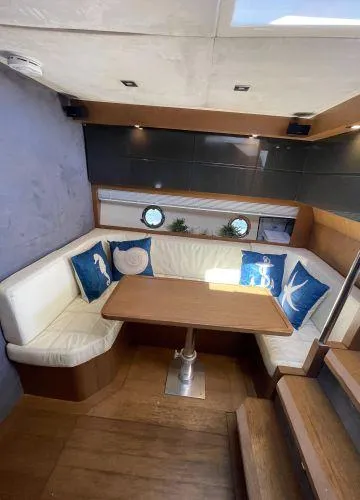  Yacht Photos Pics Interior of 2012 Azimut Atlantis 43 yacht with cozy seating and nautical decor.