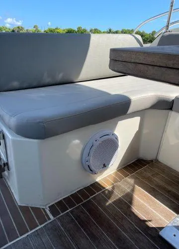  Yacht Photos Pics Azimut Atlantis 43 (2012) boat seating area with speaker, wooden flooring, and sunny weather.