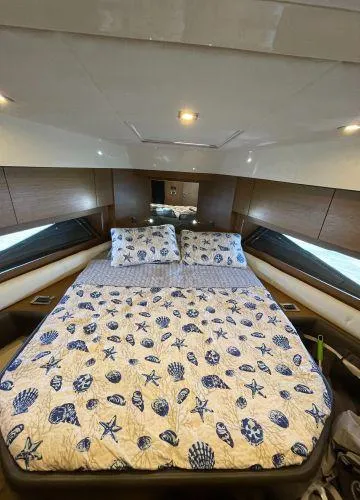  Yacht Photos Pics Luxurious bedroom interior of 2012 Azimut Atlantis 43 yacht with nautical-themed bedding.