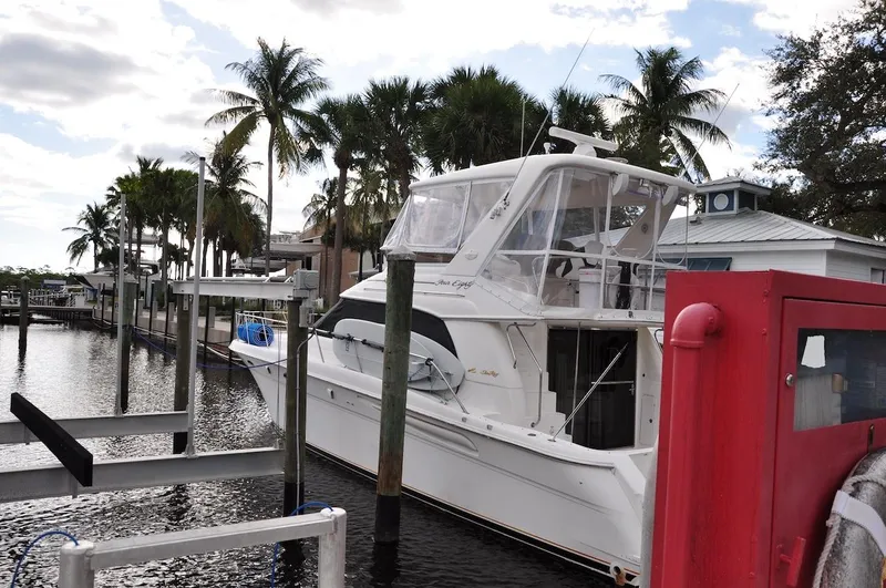  Yacht Photos Pics 1998 Sea Ray 480 Sedan Bridge docked at a marina with palm trees.