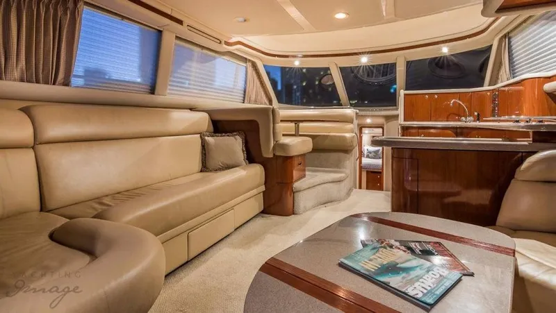  Yacht Photos Pics Luxurious interior of a 1998 Sea Ray 480 Sedan Bridge yacht with leather seating and modern kitchen.