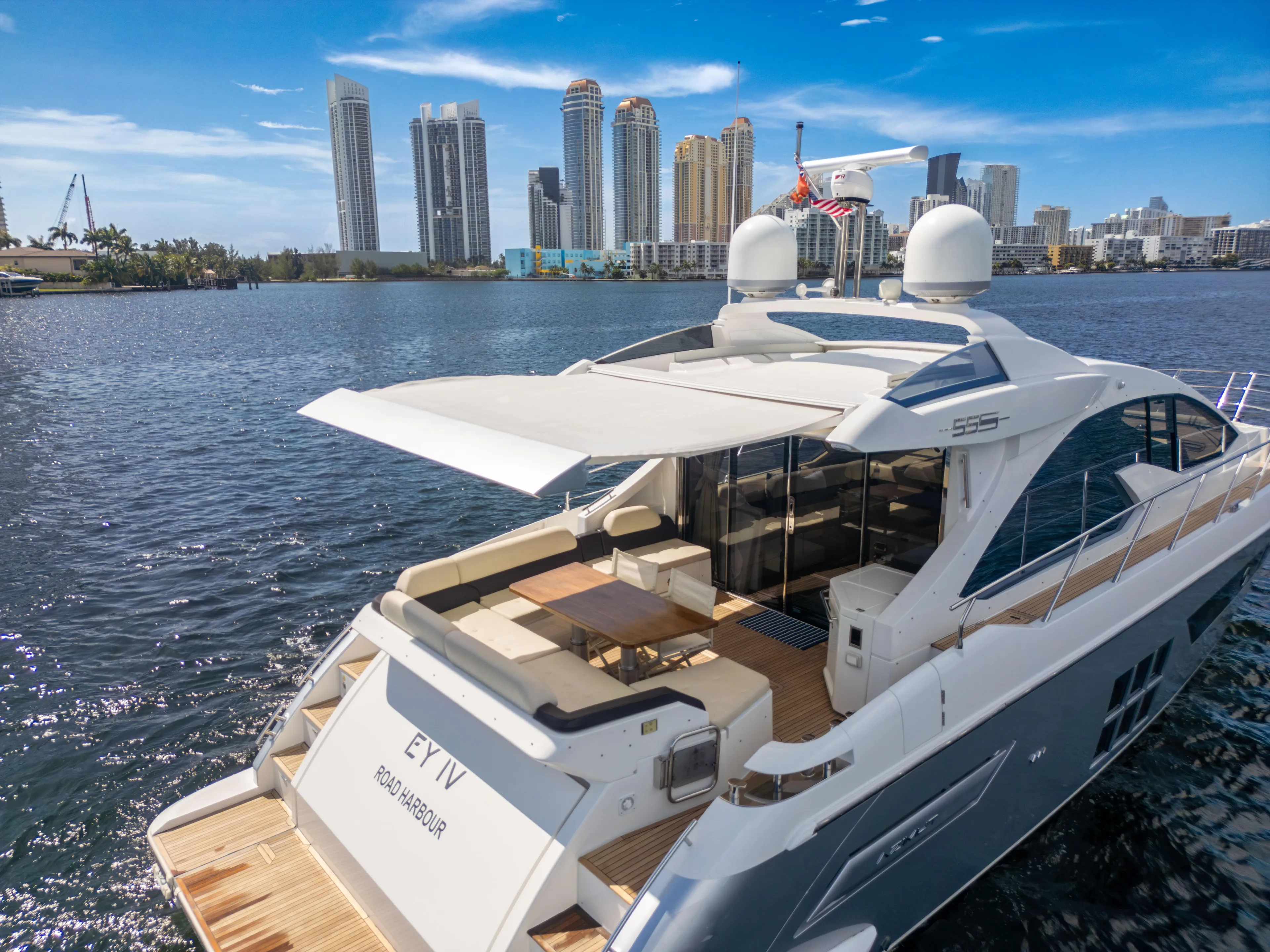 Ey IV Yacht Photos Pics Luxurious 2016 Azimut 55S yacht on water with city skyline in background.