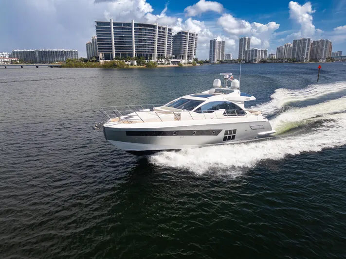 Ey IV Yacht Photos Pics 2016 Azimut 55S yacht cruising on water with cityscape background.