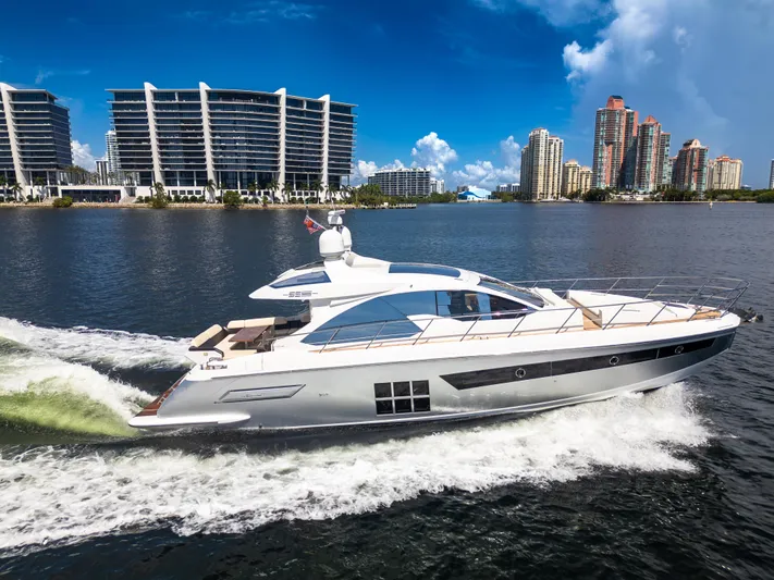 Ey IV Yacht Photos Pics 2016 Azimut 55S yacht cruising on water with city skyline in background.