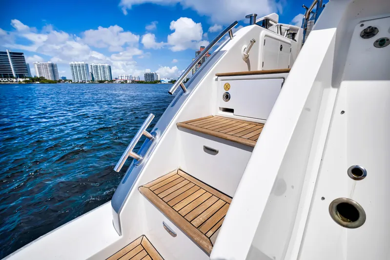 Ey IV Yacht Photos Pics Staircase on 2016 Azimut 55S yacht with wooden steps, overlooking a scenic waterfront.