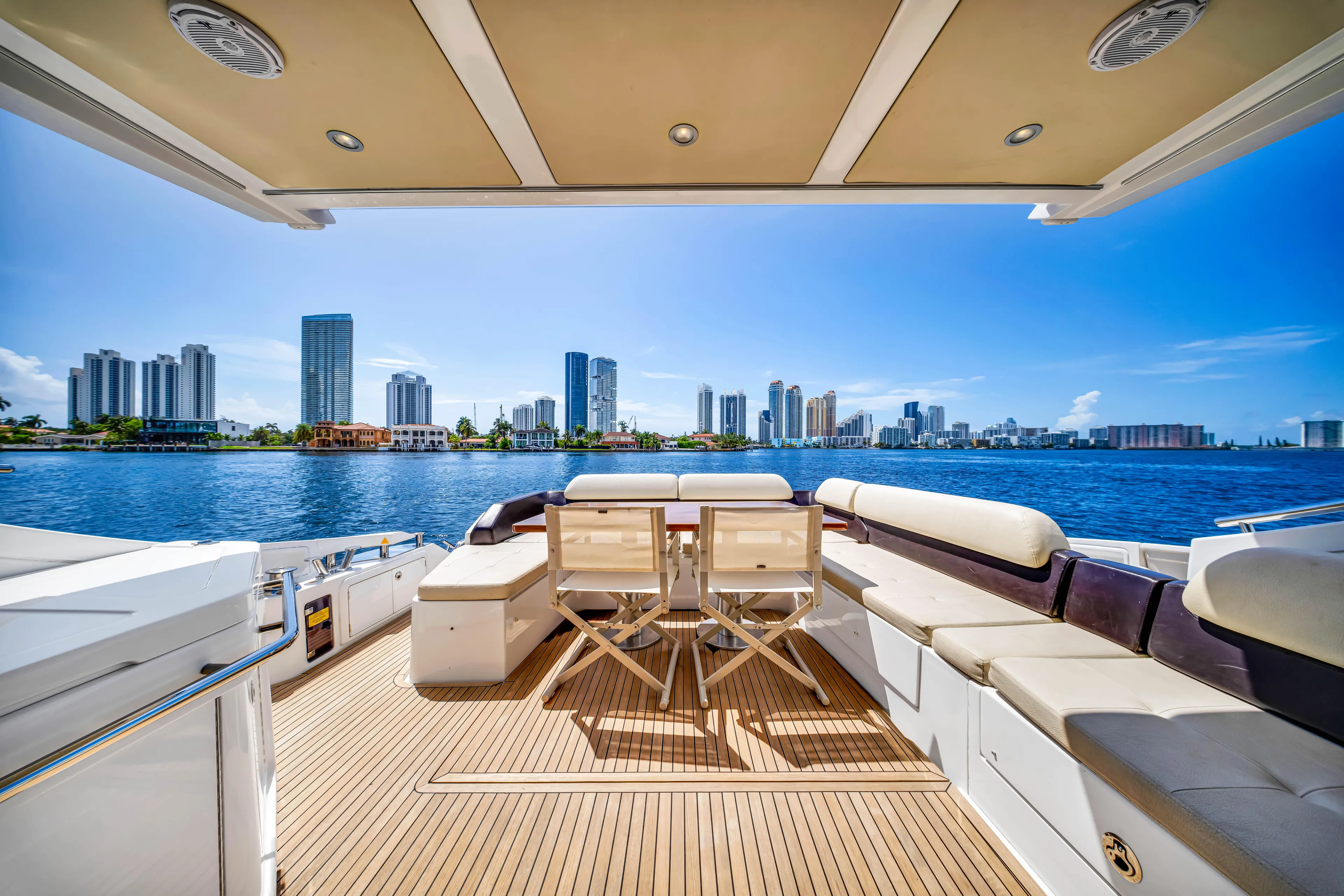 Ey IV Yacht Photos Pics Luxurious 2016 Azimut 55S yacht deck with city skyline and waterfront view.