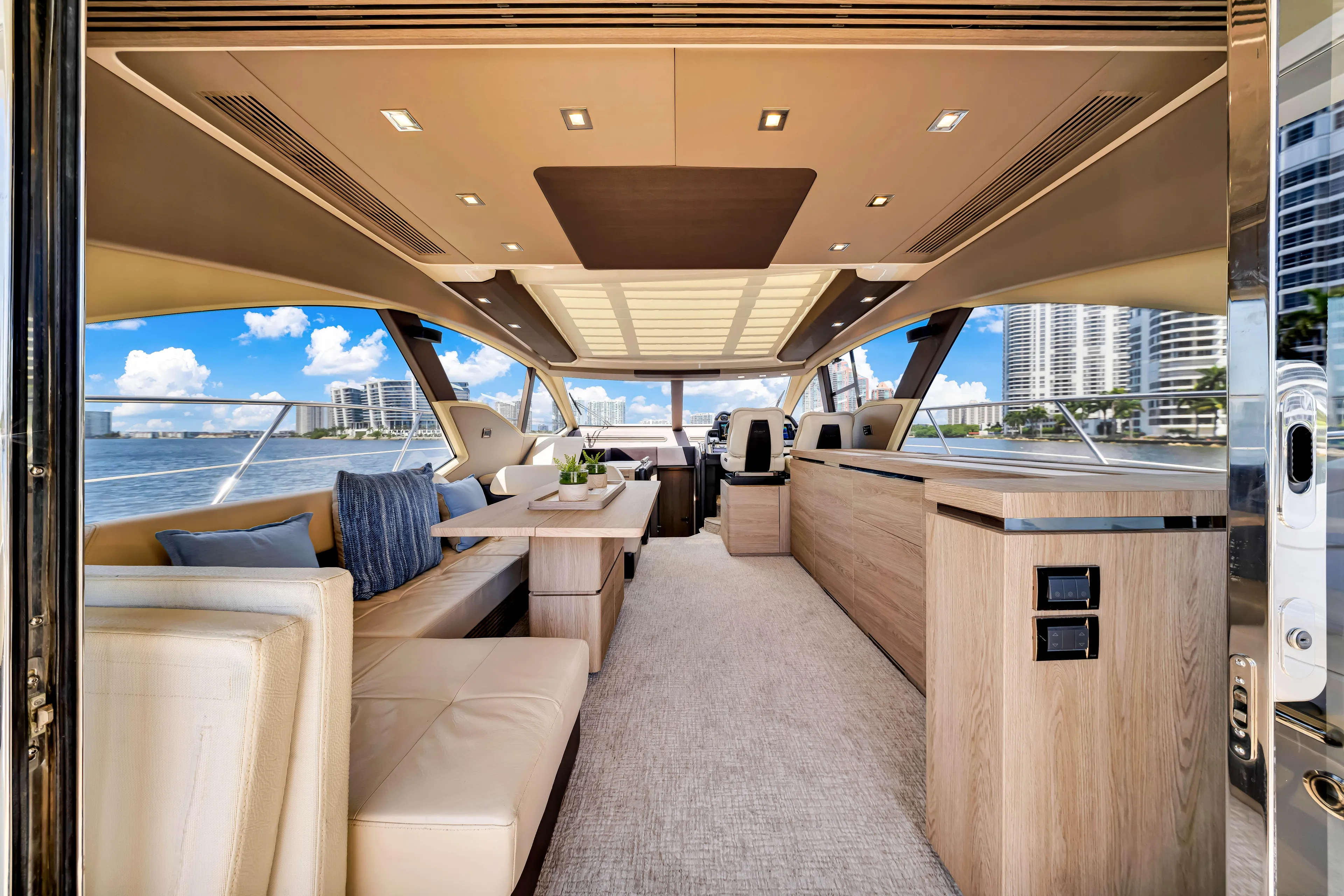 Ey IV Yacht Photos Pics Luxurious interior of 2016 Azimut 55S yacht with modern furnishings and panoramic windows.