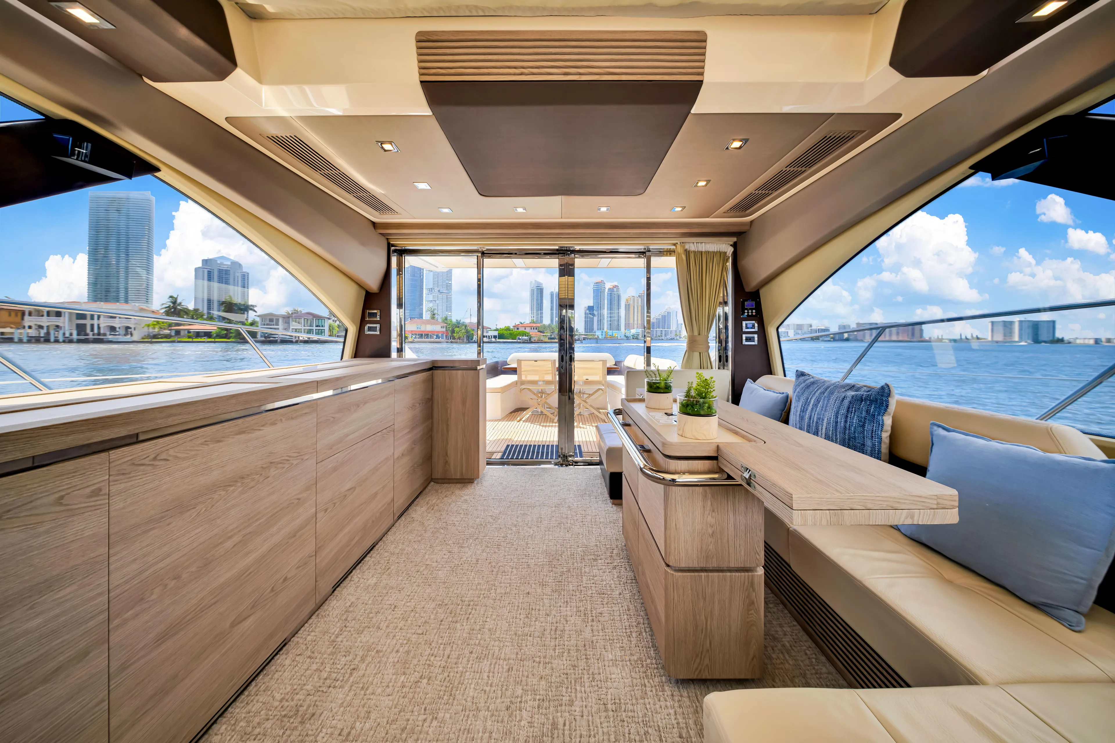 Ey IV Yacht Photos Pics Luxurious interior of a 2016 Azimut 55S yacht with modern furnishings and city skyline view.