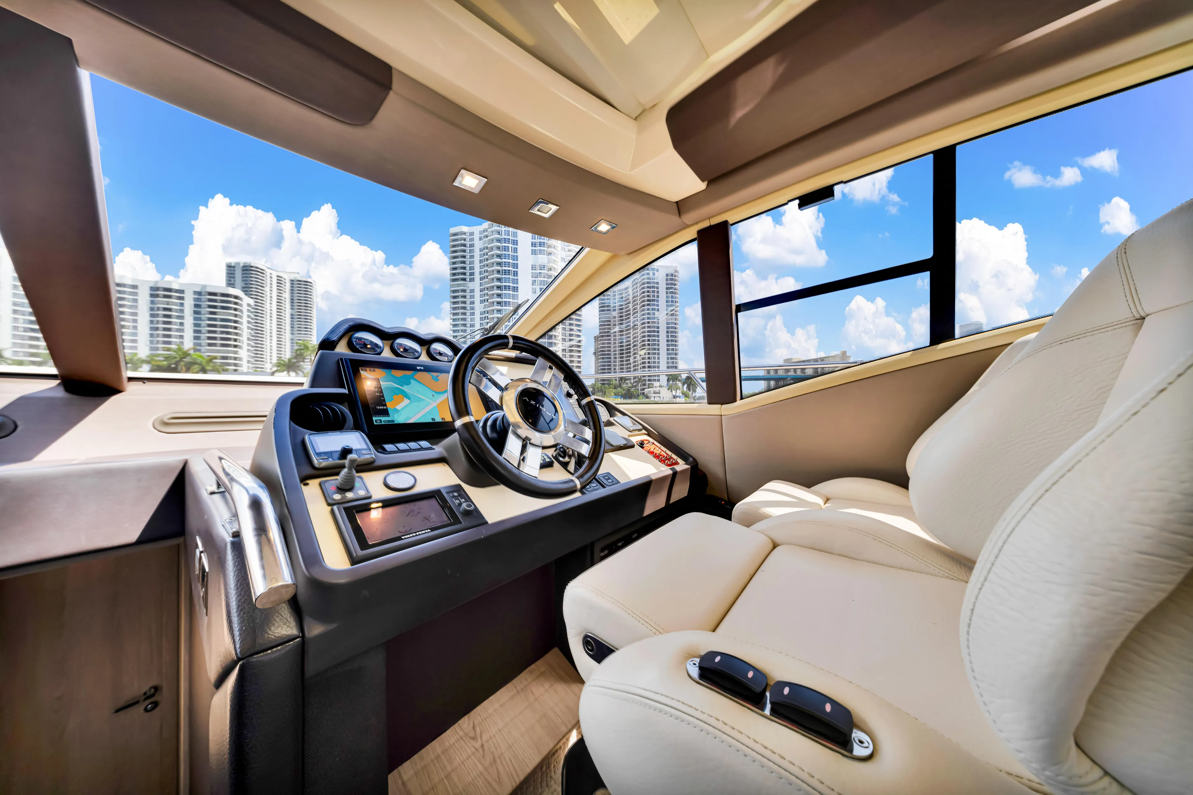 Ey IV Yacht Photos Pics Luxurious 2016 Azimut 55S yacht cockpit with modern controls and plush seating.