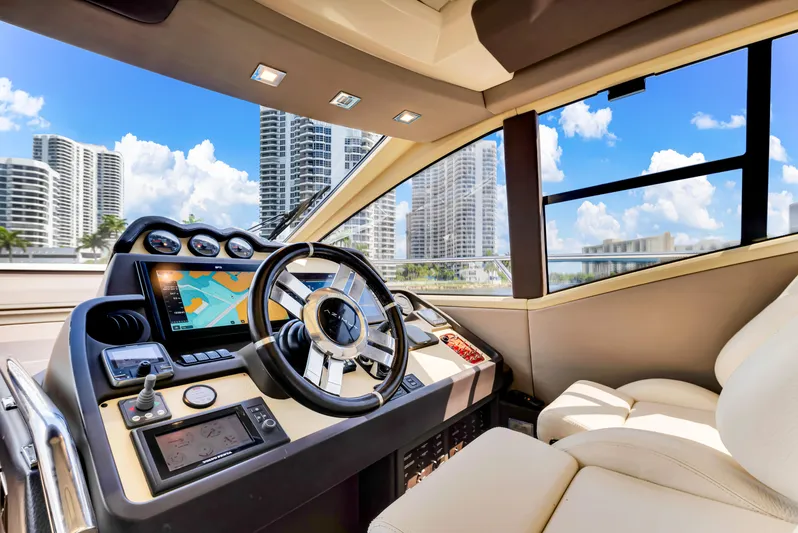 Ey IV Yacht Photos Pics Luxurious 2016 Azimut 55S yacht helm with modern controls and city skyline view.