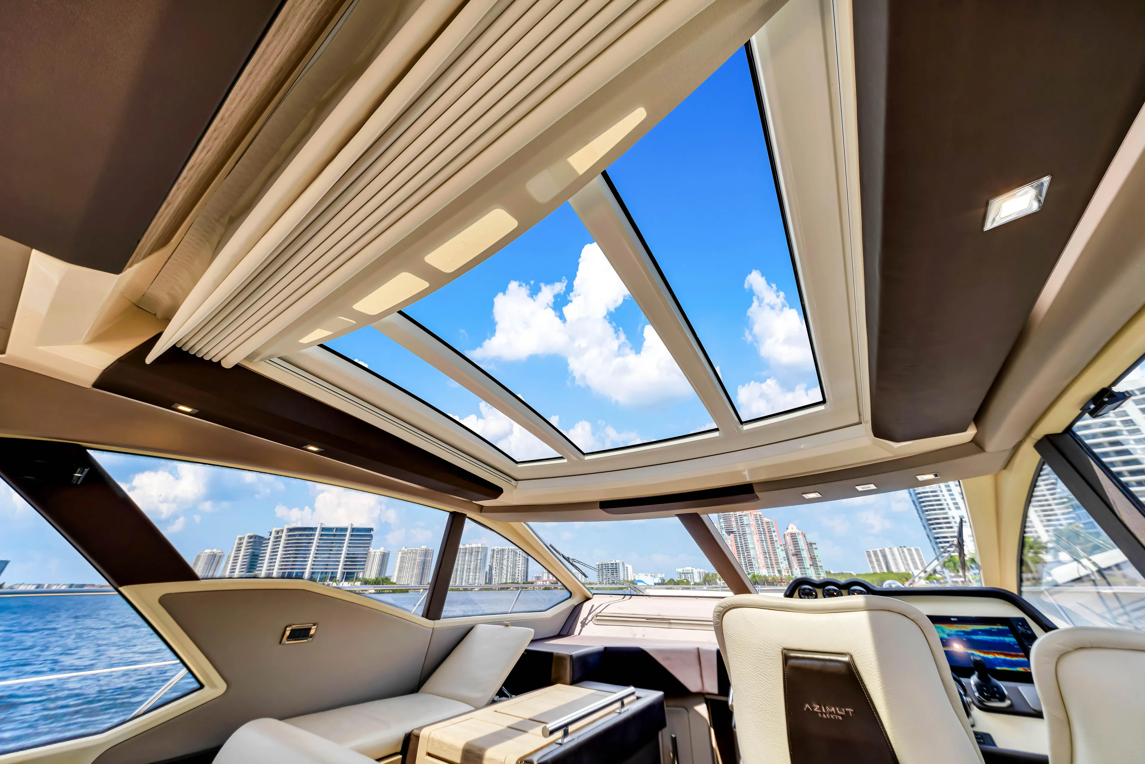 Ey IV Yacht Photos Pics Luxurious interior of 2016 Azimut 55S yacht with panoramic sunroof and waterfront view.
