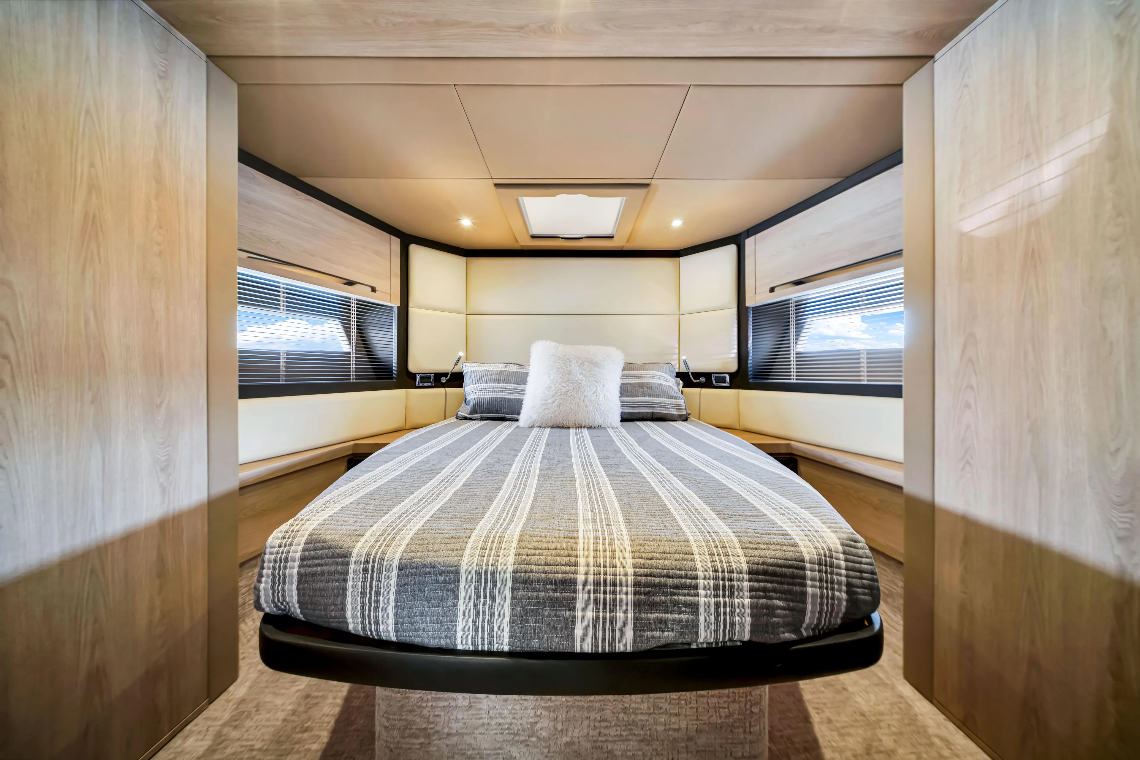 Ey IV Yacht Photos Pics Luxurious bedroom interior of 2016 Azimut 55S yacht with modern design and striped bedding.