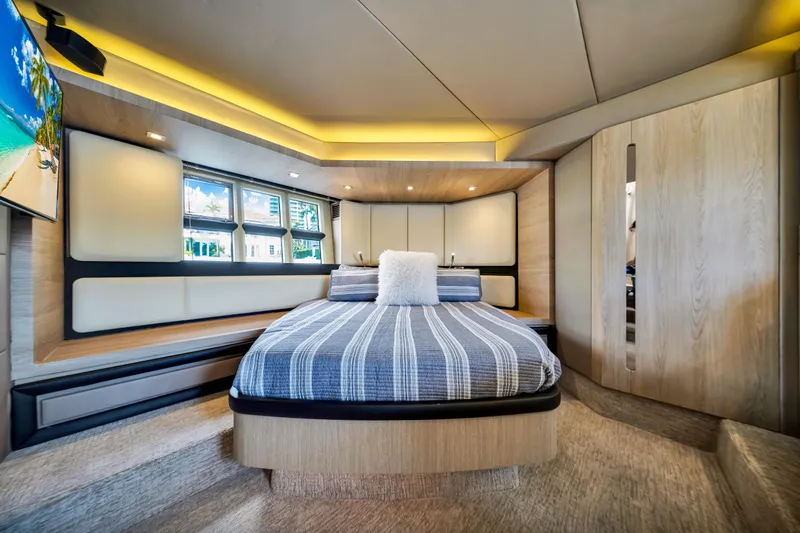 Ey IV Yacht Photos Pics Luxurious bedroom interior of 2016 Azimut 55S yacht with modern design and ambient lighting.
