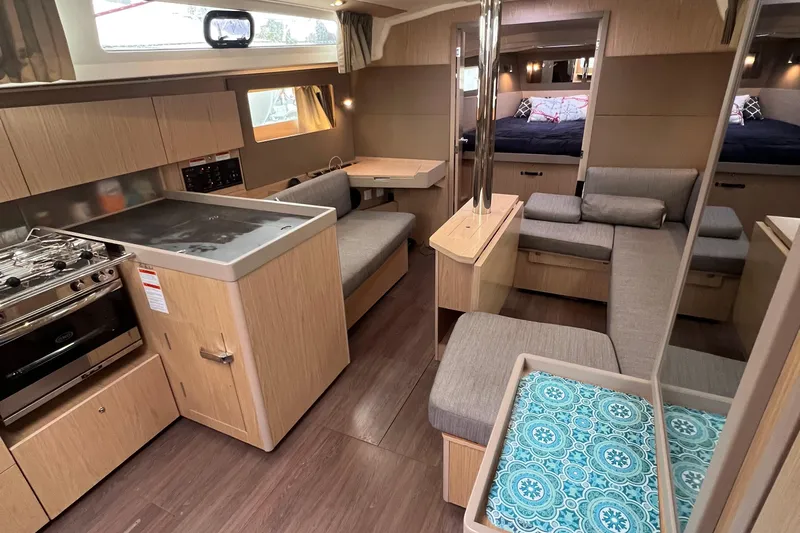  Yacht Photos Pics Interior of 2019 Beneteau Oceanis 41.1 yacht with modern kitchen and cozy seating area.
