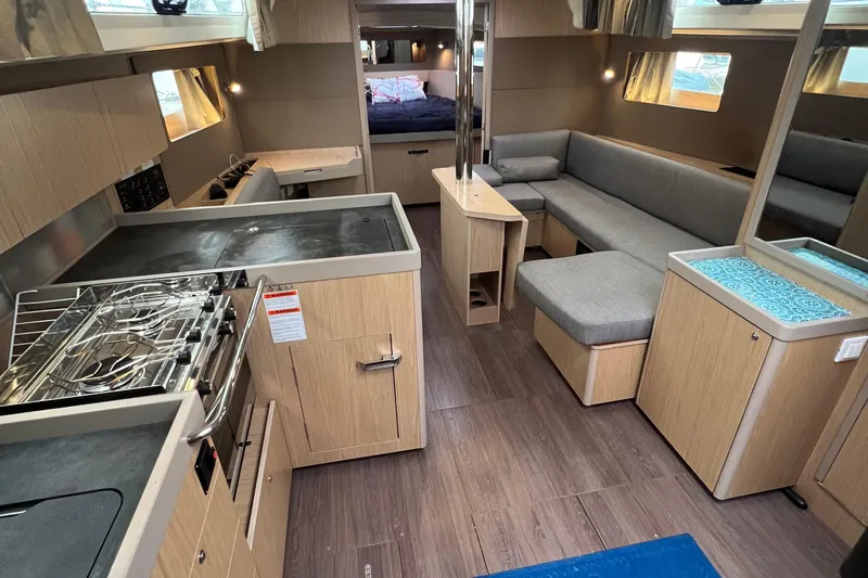  Yacht Photos Pics Interior of 2019 Beneteau Oceanis 41.1 yacht with modern kitchen and cozy seating area.