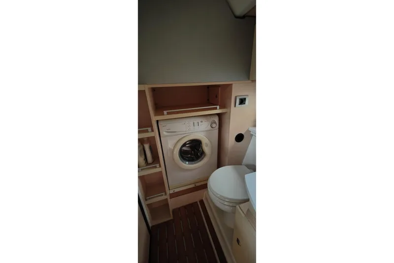  Yacht Photos Pics Laundry area with washing machine in 2016 Cranchi Atlantique 43 yacht bathroom.