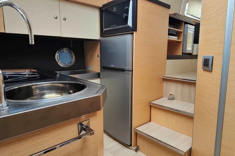  Yacht Photos Pics Modern kitchen interior of 2016 Cranchi Atlantique 43 yacht with stainless steel sink.