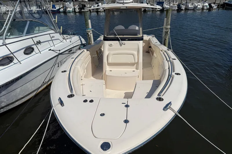  Yacht Photos Pics 2017 Grady-White Canyon 271 FS boat docked in marina, showcasing spacious deck.