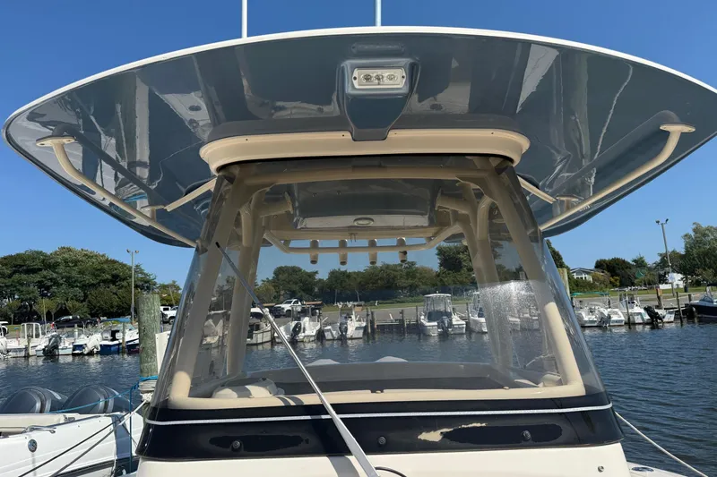  Yacht Photos Pics 2017 Grady-White Canyon 271 FS boat docked at marina under clear blue sky.
